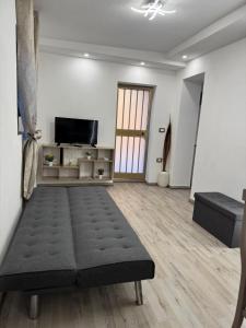 a living room with a couch and a television at Dafne Accomodation in Fitili