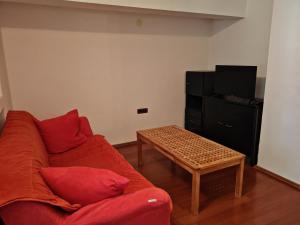 a living room with a red couch and a coffee table at Villa Finera in Premantura