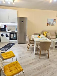 a kitchen and living room with a table and chairs at Sunrise Luxury Sauth Bay in Varna City