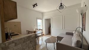 a living room and kitchen with a couch and a table at Luna di mare Igalo in Igalo