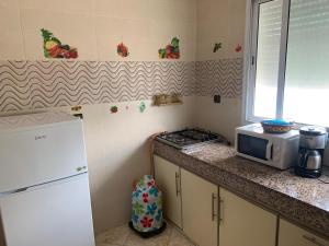 a kitchen with a microwave and a stove and a counter at Soofhouse in Fez