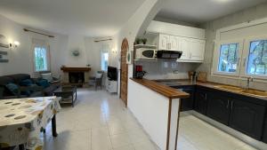 a kitchen and living room with a couch and a table at MEDDAYS Villa MARINA in Miami Platja