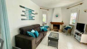 a living room with a couch and a fireplace at MEDDAYS Villa MARINA in Miami Platja