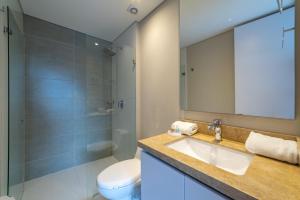 a bathroom with a sink and a toilet and a mirror at Loft en Bogota Centro Internacional in Bogotá +19 photos