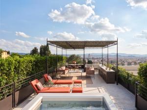 a patio with a hot tub on the roof of a house at Collegio alla Querce, Auberge Collection in Florence