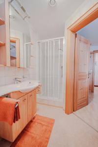 a bathroom with a sink and a shower at Bucherhof - Ferienwohnungen in Obertilliach