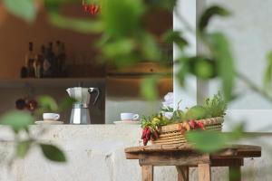 a table with a basket of flowers on it at Masseria Borgo Sentinella in Torre dell'Orso