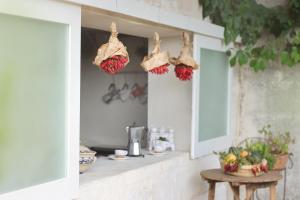a kitchen with a table and some bags on the wall at Masseria Borgo Sentinella in Torre dell'Orso