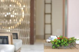 a flower arrangement on a table in a room at Masseria Borgo Sentinella in Torre dell'Orso