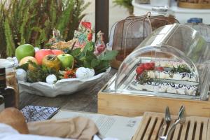 a table with fruits and vegetables in a glass container at Masseria Borgo Sentinella in Torre dell'Orso