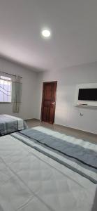 Giường trong phòng chung tại Casa confortável no Caranã +1 ảnh