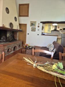 a living room with a couch and a fireplace at Casa Alima in Suvereto