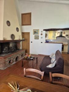 a living room with a couch and a fireplace at Casa Alima in Suvereto +7 photos