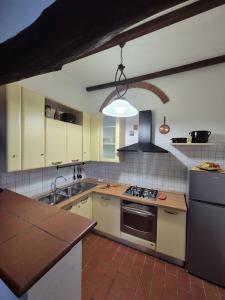 a kitchen with a sink and a stove top oven at Casa Alima in Suvereto