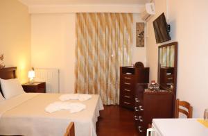 a hotel room with two beds and a mirror at Kotza Ntere in Axioúpolis