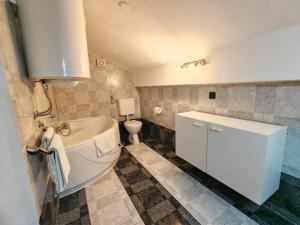 a bathroom with a white tub and a toilet at Villa Finera in Premantura +21 photos