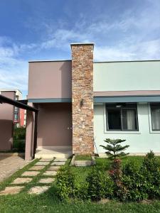 een huis met een stenen schoorsteen bij Entebbe Waterfront Home in Kagolomolo