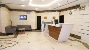 a lobby of a hospital with a counter and chairs at ريف الشرقية للشقق الفندقية in Dammam