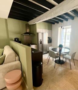 カルカソンヌにあるLa Loge des Rempartsのテーブルとキッチンのあるリビングルーム