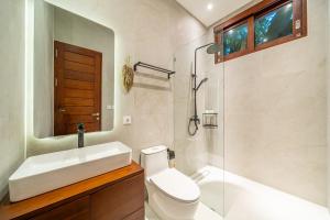 a bathroom with a sink and a toilet and a shower at Kesari 5 - Beachside Bliss - Brand New 3BR Villa with Huge Pool in Sanur +11 photos