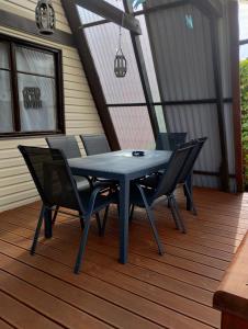 a blue table and chairs on a deck at Domek letniskowy 36 in Giżycko