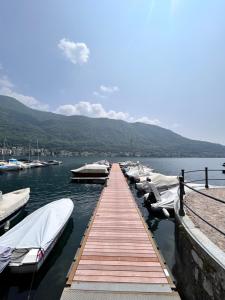 a group of boats docked at a dock on a lake at LA CASETTA TRA i LAGHI in Omegna