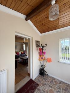 a hallway with a wooden ceiling and a room at Ballyhornan Getaway in Ballyhornan