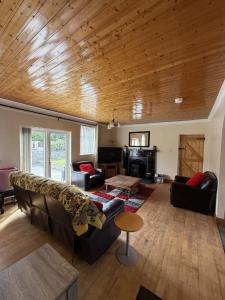a living room with a couch and a table at Ballyhornan Getaway in Ballyhornan +11 photos