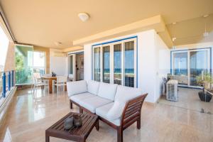 a living room with a white couch and a table at 426 Casa Onda Mirabaia in Albardeira
