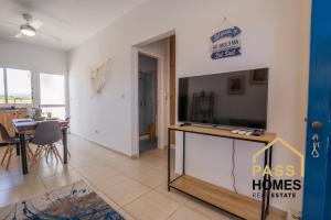 a living room with a large flat screen tv at Morski zakątek in Polis Chrysochous