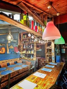 a bar with a large wooden table in a room at Nature Neno in Visoko