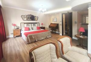 a bedroom with a bed with a tv on the wall at Tanguero Hotel Boutique Antique in Buenos Aires