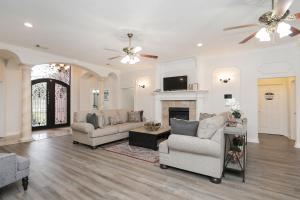 a living room with two couches and a fireplace at Private Backyard Oasis Spacious Home in Humble! in Houston