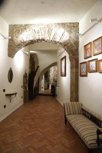a living room with a stone wall and a couch at Odeon Neapolis - Historic Suites in Roman Theater in Naples