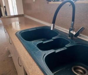 a sink with a faucet in a kitchen at Ανετο 2 in Artemida