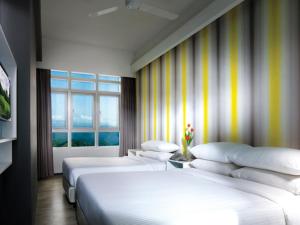 a hotel room with a large bed and a large window at Resorts World Genting - First World Hotel in Genting Highlands