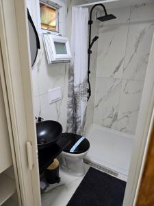 a small bathroom with a toilet and a shower at Cabana Mura in Olăneşti +28 photos