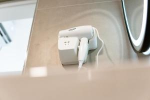 a white electrical device sitting on a table at Tepelena Center Hotel in Tepelenë