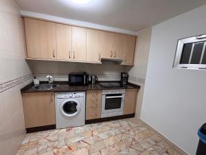 a kitchen with a washing machine and a sink at GaliciaGuestHome Peregrina 18 in Pontevedra