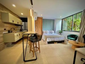 a kitchen and a bedroom with a bed and a sink at Nomadic Boutique Living and Experience Center in Medellín