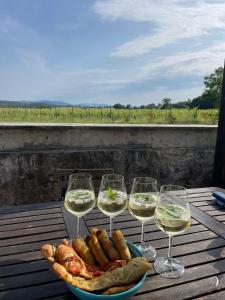a plate of food and wine glasses on a table at Agriturismo La Segolina in Colle Val D'Elsa