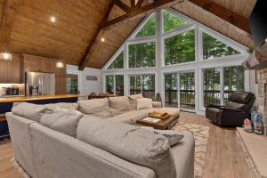 a living room with a large couch and a table at Tranquility Point in Lac du Flambeau WI in Lac du Flambeau