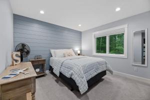 a bedroom with a bed and a window at Tranquility Point in Lac du Flambeau WI in Lac du Flambeau