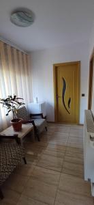 a living room with a door and a table and chairs at Casa Ella in Tuzla