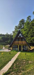 a yellow house with a gambrel roof at Vikendica Buzadzija M&N 