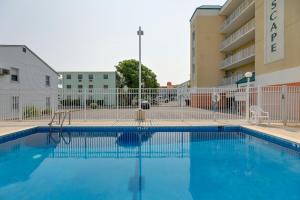 a swimming pool in front of a building at Steps to Beach Ocean City Getaway with Pool Access! in Ocean City
