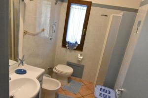 a bathroom with a toilet and a sink and a shower at Villa Venere in Domus de Maria +33 photos