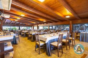 a dining room with tables and chairs and windows at L'isola felice in Silvi Marina