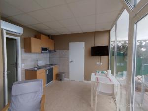 a kitchen with a table and chairs and a kitchen with a sink at Apartment Mariposa Azul in Icod de los Vinos