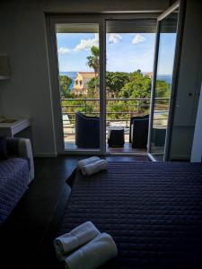 a room with a balcony with a view of the ocean at Villa al Plemmirio Luxury in Plemmirio